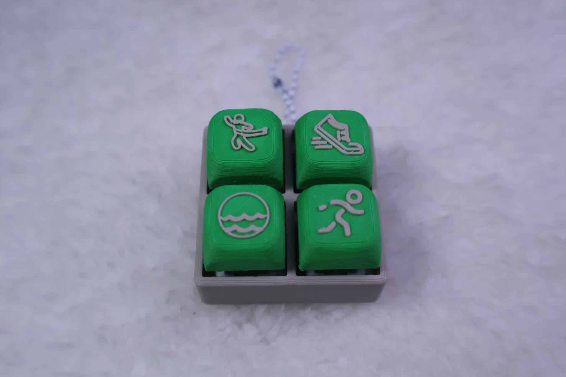 Green four-button activity clicker keychain